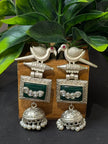 Pair of silver earrings with green gemstones 