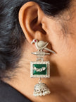 ornate silver earring with green stone