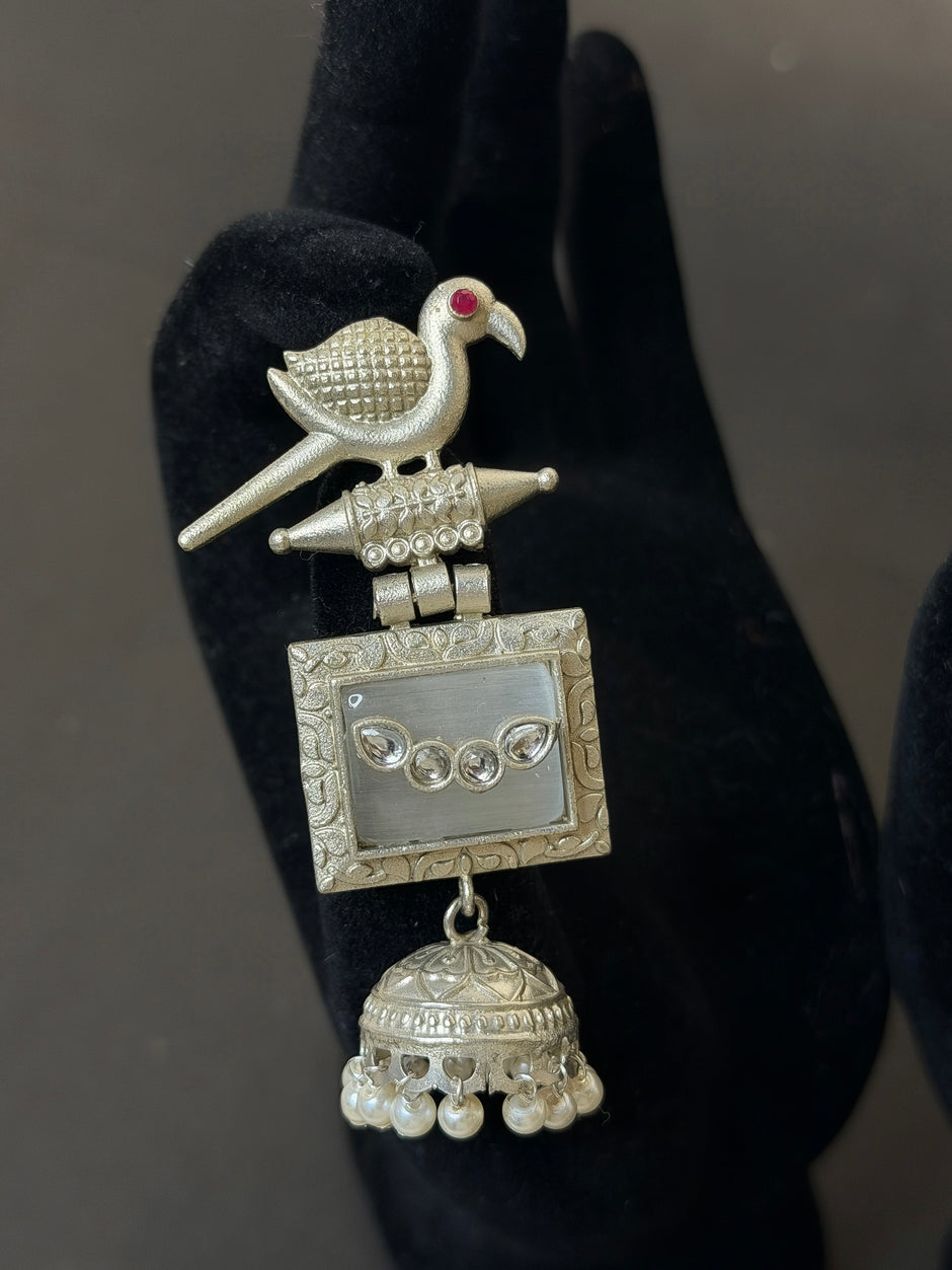 Decorative silver pendant with a bird design