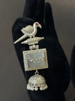 Decorative silver pendant with a bird design
